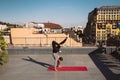 Young woman working out outdoors and doing yoga handstand exercise Royalty Free Stock Photo