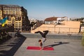 Young woman working out outdoors and doing yoga handstand exercise Royalty Free Stock Photo