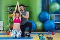 Young woman working out with personal trainer at the gym. Royalty Free Stock Photo