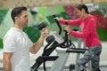 Young woman working out with personal trainer at gym Royalty Free Stock Photo