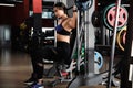 Young woman working out on Smith machine in gym Royalty Free Stock Photo