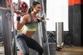 Young woman working out on Smith machine in modern gym Royalty Free Stock Photo