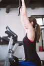 Young woman working out on weight lifting training ma Royalty Free Stock Photo