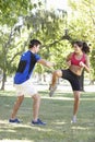 Young Woman Working With Personal Trainer In Park Royalty Free Stock Photo