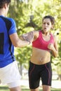 Young Woman Working With Personal Trainer In Park Royalty Free Stock Photo