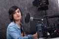 Young woman working on the radio studio