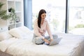 Young woman working remotely from home, typing on modern wireless laptop. Royalty Free Stock Photo