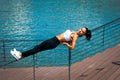 Young woman workout on balance outdoor in the city promenade by Royalty Free Stock Photo