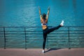 Young woman workout stretching outdoor in the city promenade by Royalty Free Stock Photo