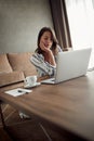 Young woman works for a computer from a home with a laptop as a freelancer Royalty Free Stock Photo