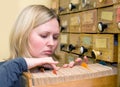 Young woman works with library card index