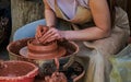 A young woman works on a potter's wheel. Traditional craft training