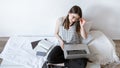 A young woman works remotely at a computer at home