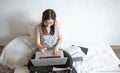 A young woman works remotely at a computer at home