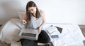 A young woman works remotely at a computer at home