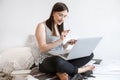 A young woman works remotely at a computer at home