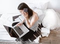 A young woman works remotely at a computer at home