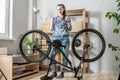 Woman next to a bicycle is showing two thumbs up. Concept of maintenance and preparation of the bike for the new season Royalty Free Stock Photo