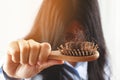 Young woman worried about Hair loss problem after comb in hand. problem hormonal disbalance, stress concept. Royalty Free Stock Photo