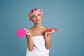 Young woman wrapped towel posing with shower sponge and gel Royalty Free Stock Photo