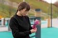 Young woman wrapping a wrist wrap around her hand before outdoor martial arts training Royalty Free Stock Photo