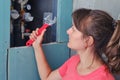 Young woman with a wrench. Plumbing repairs with their own hands. The girl looks at the water meters with a tool in his hand