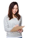 Young woman write on clipboard Royalty Free Stock Photo