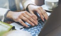 Young woman writes hands a text message on laptop keyboard with a empty blank screen monitor while having recreation time at home Royalty Free Stock Photo