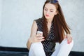 Young woman writes an SMS to your mobile phone Royalty Free Stock Photo