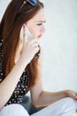 Young woman writes an SMS to your mobile phone Royalty Free Stock Photo