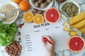 Young woman is writing a diet plan Royalty Free Stock Photo