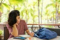 Young woman writing in notebook outdoors in tropical location Royalty Free Stock Photo