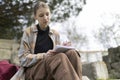 Young woman writing outdoors in urban setting Royalty Free Stock Photo