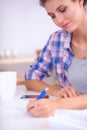 Young woman writing something in her note pad Royalty Free Stock Photo