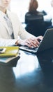 Young woman writing text hands on the open laptop in a cafe on a table with reflection , businesswoman working on comput