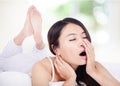 Young woman yawning in bed in the morning Royalty Free Stock Photo