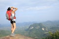 Young woman yelling at mountain peak Royalty Free Stock Photo