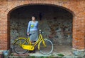 Young woman with yellow bike