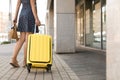 Young woman with yellow carry on suitcase Royalty Free Stock Photo