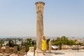 Young woman in yellow dress in front of the Carthage ancient ruins, Tunis, Tunisia