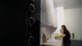 Young woman in yellow rubber gloves in the kitchen is washing dishes by hand. Royalty Free Stock Photo