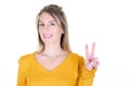 Young woman with yellow sweater over isolated white background smiling showing victory finger sign Royalty Free Stock Photo