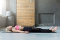 Young woman in yoga class, relax meditation corpse pose Royalty Free Stock Photo