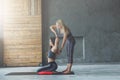 Young woman with yoga instructor in fitness club, gomukhasana Royalty Free Stock Photo