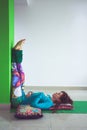 Young woman in yoga relaxing pose with legs up the wall Royalty Free Stock Photo