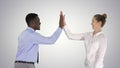 Young woman and young man in formal clothes give high five on gr Royalty Free Stock Photo