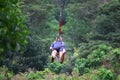 Young woman on zipline above the jungle Royalty Free Stock Photo