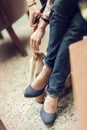 Young womans feet close up in a street cafe, urban mood Royalty Free Stock Photo