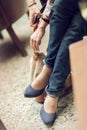 Young womans feet close up in a street cafe, urban mood