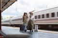 Young womans female traveler looking on map at train station. travel concept Royalty Free Stock Photo